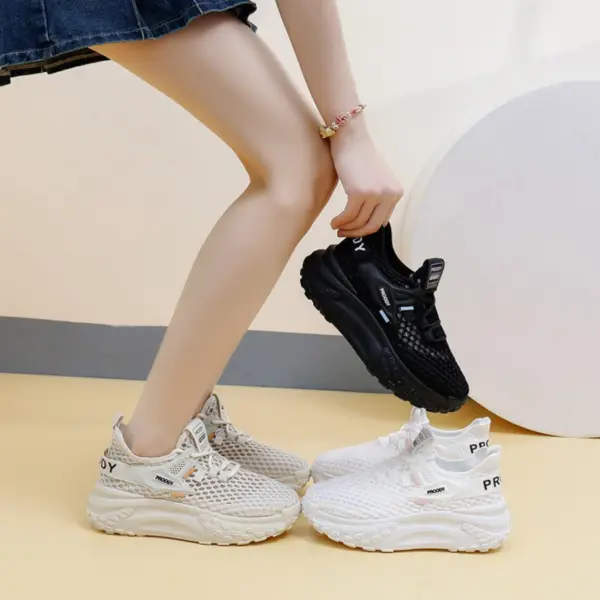 Wearing 2025 Summer New Style Mesh Round Toe Sneakers, a woman holds black sneakers while another white pair rests on the yellow floor. These lace-up women’s shoes are affordable and designed for slow walking.