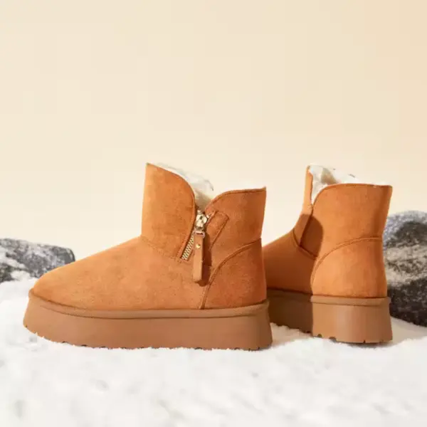 New Design Ladies Warm Winter Snow Ankle Boots for Women—tan suede, side zippers, thick soles, shown on snow with rocks. OEM and ODM custom options available. Fashion platform boots 2025.