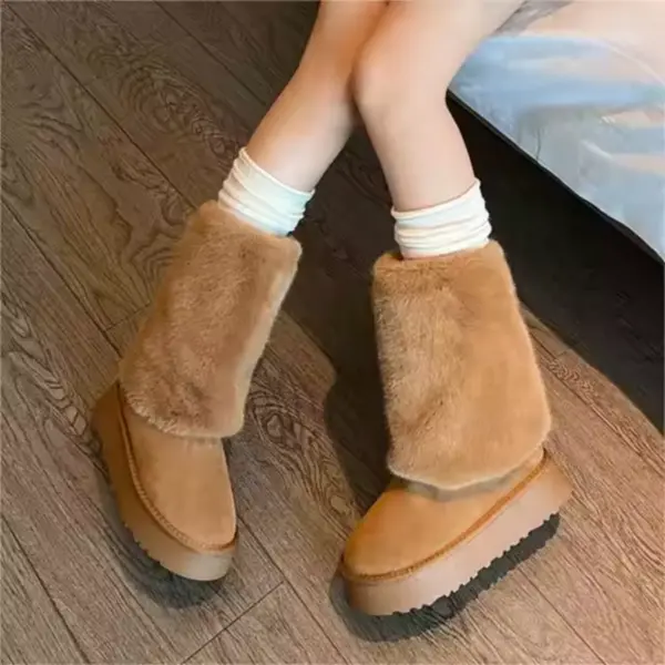 A person sitting on a bed wears Wholesale Winter New Styles Women Plus Plush Platform Non slip Snow Boots Cotton Floette Plush Shoes for Ladies with white socks on a wooden floor.