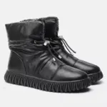 A pair of wholesale customized plush thick genuine leather waterproof bread cotton fur boots, designed for women, with OEM/ODM options—perfect snow winter boots featuring quilted uppers and drawstring closures.