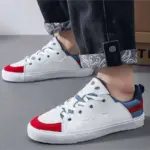 A person wearing Customizable Retro Mixed Stylish Plush Walking Sneakers—lightweight, breathable women’s shoes—paired with black jeans that have patterned cuffs.