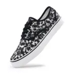 The 2025 Factory New Style Mixed Trendy Adult Canvas Shoes feature a black and white floral pattern, black laces, and a white rubber sole—perfect for OEM/ODM customization and outdoor walking.