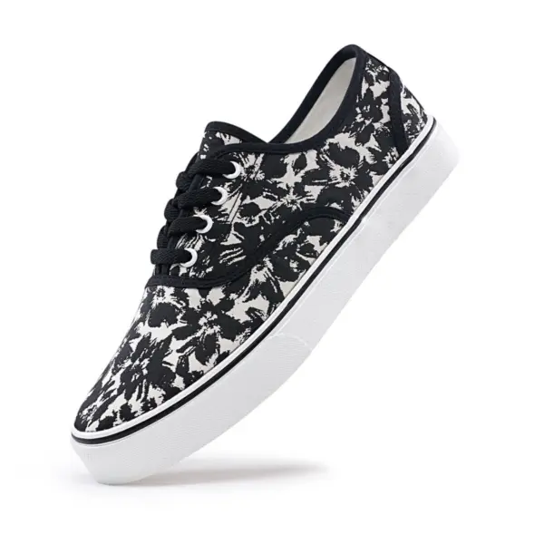 The 2025 Factory New Style Mixed Trendy Adult Canvas Shoes feature a black and white floral pattern, black laces, and a white rubber sole—perfect for OEM/ODM customization and outdoor walking.