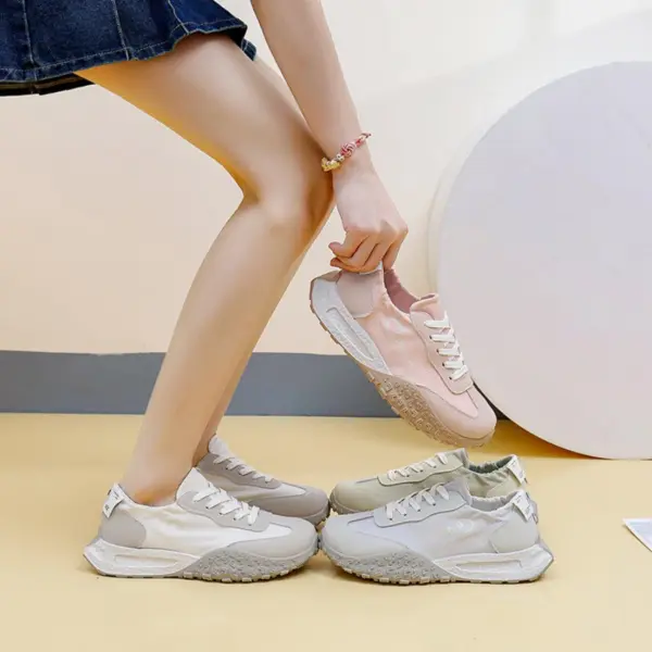 A person in a skirt and beige sneakers picks up a pair of New Mesh Breathable Sports Sneakers Summer PU Women's Rubber Lace-up Shoes in pink, with two more pairs nearby.