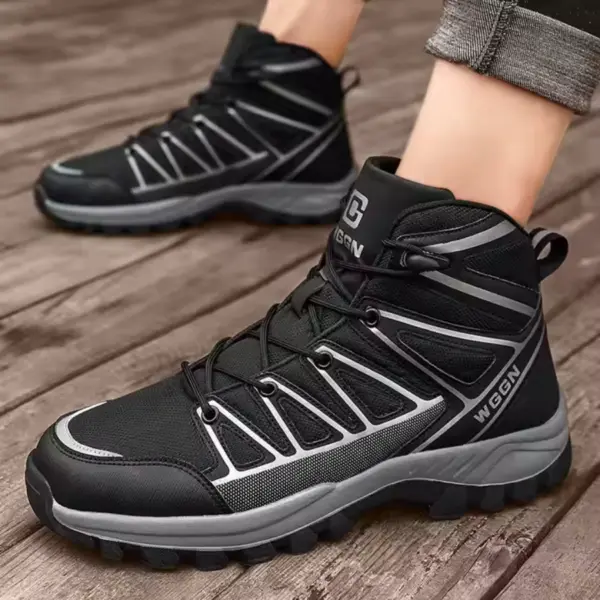 A person wearing black and gray "WGGN" Wholesale Customizable PU Warm Snow Boots—wear-resistant, anti-slip rubber men's hiking shoes for OEM/ODM—stands on a wooden surface.