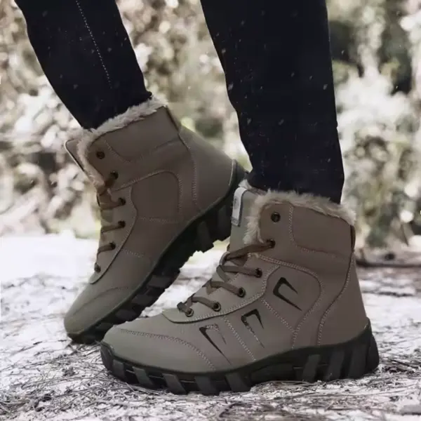 Someone wearing Customized Plush Laced Winter Snow Boots Anti Slippery Warm Waterproof Rubber PU Cotton Shoes and black pants stands outdoors on a snowy surface.