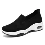 The Fashion Slip On Custom Mesh Sneakers Sports Women Running Shoes 2024 feature a black design, thick white sole, visible air-cushioned heel, and anti-slip tech—ideal for OEM/ODM customization. Shown on a plain white background.