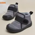 A pair of XRH Cold Sticky Casual Customized Ladies Winter Children's Baby Short Snow Boots for kids with black Velcro straps and rubber soles on a light surface—ideal for OEM/ODM customization.