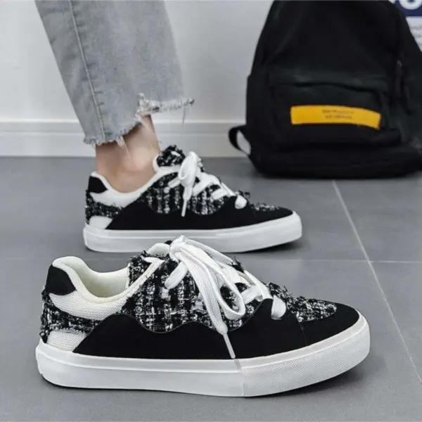 A person wearing 2025 Wholesale ODM Custom Summer New Canvas Sneakers stands on a gray floor with a black backpack in the background.