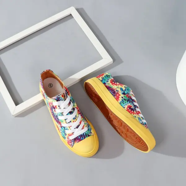 Wholesale Shoes: Classic low-top canvas sneakers with blue and yellow tie-dye uppers, yellow soles, and white laces. Perfect for school and sports. OEM & ODM customization available. Displayed on gray background with white frame. Hot sale!.