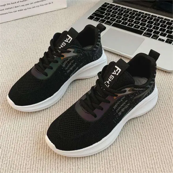 A pair of Factory Custom Spring New Styles Sports Sneakers—chunky, non-slip, height-increasing women's shoes in black with white soles—designed for OEM ODM, is placed on a beige carpet beside a silver laptop.