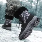 A person wearing camouflage pants and Wholesale Black Mixed Anti slip Women Snow Boots with TPR PU canvas, plush lining, and laced cotton shoes is walking on snowy ground.