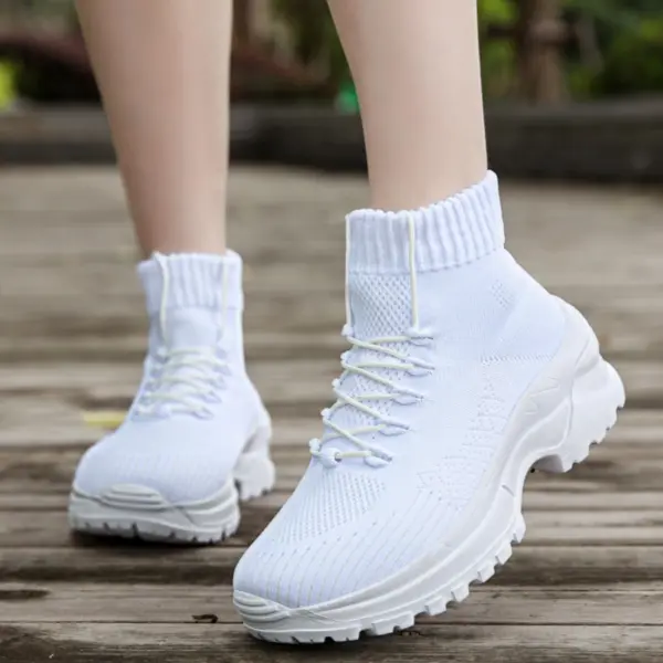 A person wearing XRH Wenzhou Factory Thick Bottom Increase Sneaker High Top Casual Running Chunky Shoes stands on a wooden surface outdoors.