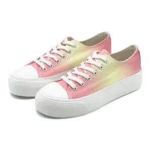 A pair of ODM wholesale mixed colored low top vulcanized canvas shoes with thick bottoms, white soles and laces, plus size flats featuring a gradient pink and yellow design.