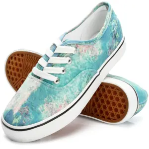 A pair of Wholesale China Factory round toe unisex tie-dye canvas shoes for women with blue and white marbled pattern, lace-up design, white soles, and brown waffle-patterned treads.