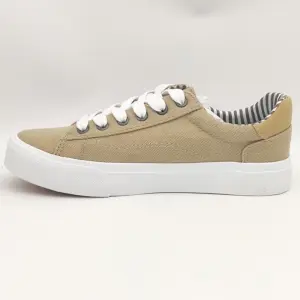 New Arrivals wholesale band vulcanized fashion leather casual canvas shoes for men in beige with white laces, white sole, striped inner lining—displayed on a plain white background. Available for OEM/ODM customization.