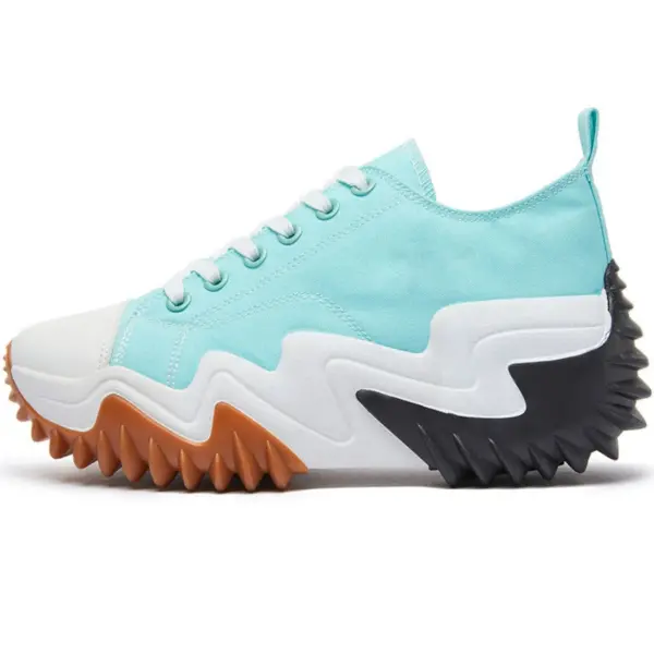 The XRH Wholesale Plain Casual Mujer Ladies Sneaker features a light blue canvas, white toe cap and laces, plus a chunky jagged sole in brown, black, and white—custom logo available for trendy walking style.