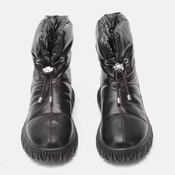 A pair of black genuine leather waterproof snow boots with plush thick fur, quilted uppers, drawstring closures, and textured rubber soles—ideal for OEM/ODM customization.