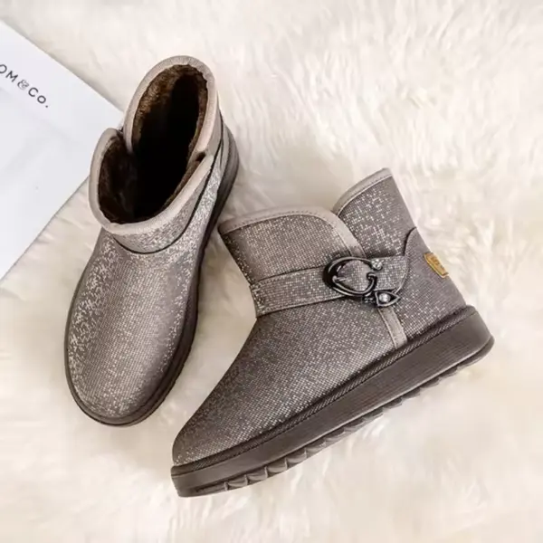 A pair of gray wholesale customized OEM ODM plush thick waterproof faux fur winter ankle boots for women, ideal for snow, displayed on a white fuzzy surface.
