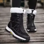 Close-up of a person wearing 2025 Spring Wenzhou Factory Zipper Women Casual Waterproof Fur Winter Outdoor Medium Snow Boots, featuring white fur lining and thick soles—ideal for OEM ODM customization.