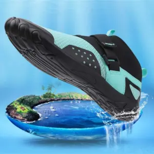 A pair of OEM ODM Outdoor Wholesale Beach Flats Fishing Fitness Waterproof Sport EVA Breathable Water Shoes in teal and black hovers above a small tropical island surrounded by blue water, splashes near the sole.