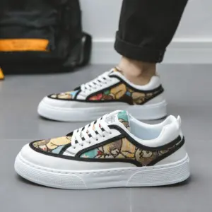 A person wearing Wholesale Factory 2024 Rubber Embossing Canvas Shoes featuring a colorful, abstract pattern and thick white soles stands indoors on a gray floor.