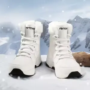 A pair of white OEM ODM winter waterproof anti-slip warm snow boots for women with fur lining and "OUTDOOR" on the tongue, shown on snowy ground with mountains—factory direct solid PU cotton shoes, customizable.
