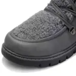 Close-up of a black leather women's winter boot with high top and flat heel, featuring thick laces and sturdy treaded sole—ideal for OEM ODM customization. Wholesale low price available.