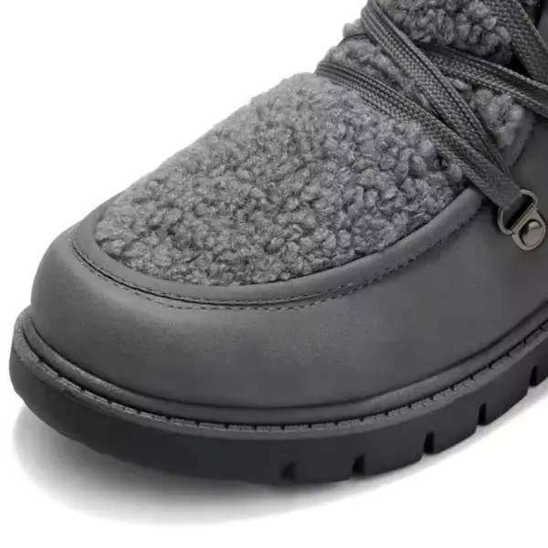 Close-up of a black leather women's winter boot with high top and flat heel, featuring thick laces and sturdy treaded sole—ideal for OEM ODM customization. Wholesale low price available.
