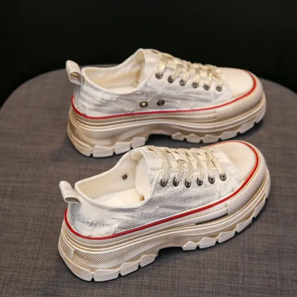 A pair of WomenS Casual Walking Style Canvas Shoes Chunky Shoes for Women, featuring white distressed canvas, thick beige soles, and red details, are displayed side by side on a gray fabric surface.