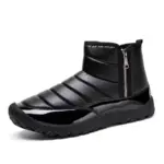 A shiny black ankle-high snow boot with a quilted upper, side zipper, round glossy toe, and textured TPR sole—ideal for OEM/ODM; Wholesale New Fashion Outdoor Cotton Winter Boots for men and women.