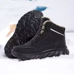 A pair of High Quality 2024 Men Custom Lace up Ankle Snow Boots are displayed on snow, one upright and one tilted to show the rugged sole and fur lining, highlighting premium OEM ODM craftsmanship.