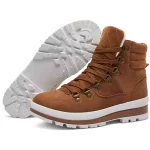 A pair of brown OEM & ODM warm classic high-top women’s snow ankle boots with zippers and white lug soles, one upright and one displaying the tread.