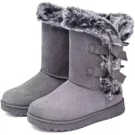 A pair of Fashion Walking Style Boots for Women—gray suede winter boots with faux fur trim, decorative side bows, flat rubber sole—ideal for OEM and ODM customization at a low price.