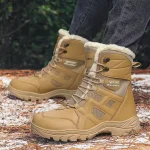 A person wearing Wholesale Customized New Winter Outdoor Laced Large Size Warm Snow Boots High Top Rubber Men's Shoes stands on a forest floor with patches of snow and pine needles.