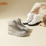 Two pairs of New Arrivals Classic Lace up Hiking Combat Ankle Boots for Women 2025 are displayed on a beige surface next to a fluffy beige and white blanket, available for OEM ODM orders.