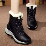 A woman stands on a brown carpet wearing New Arrivals Waterproof Lace up PU Upper Fur Lined Warm Women's Snow Winter Boots, featuring black exterior, white faux fur lining, and thick rubber soles.