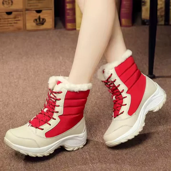 A woman wearing New Arrivals waterproof lace-up PU upper fur-lined warm women's snow boots in red and beige sits cross-legged on a carpeted floor.