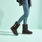 A person poses in blue skinny jeans, a plaid coat, and New Fashion Style Platform Snow Waterproof Outdoor Boots for Women—Warm Winter Shoes Boots 2024—against a mint green background, perfect for OEM ODM fashion inspiration.