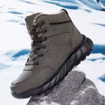 The High Quality 2024 Men Custom Lace up Ankle Snow Boots Shoes for Men are shown on a rock, with black laces and a thick black sole, set against a snowy landscape. OEM/ODM options available.