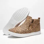 A pair of 2025 New Black Beige Snake Leopard Ankle Boots for women—one boot upright and the other on its side, featuring winter leather and ladies’ design.